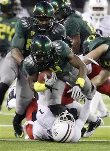 Oregon wide receiver Josh Huff (4) runs over Arizona's Robert Golden (1)