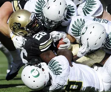 Colorado RB Tony Jones (26) is is gang tackled during the first half.