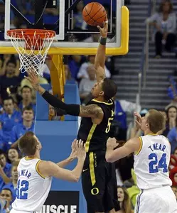 Oregon center Tony Woods (55) dunks over