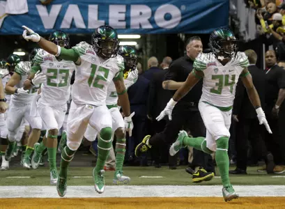 Oregon players take the field for the