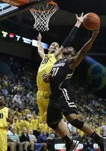 Oregon's Waverly Austin (20) swats away