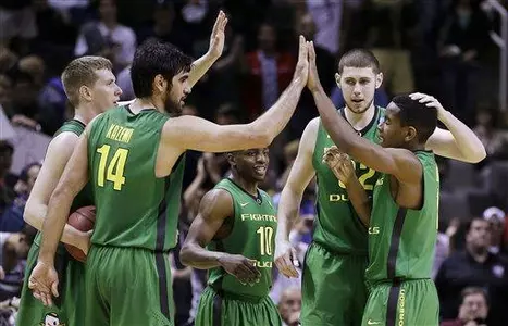 Oregon players celebrate on the court