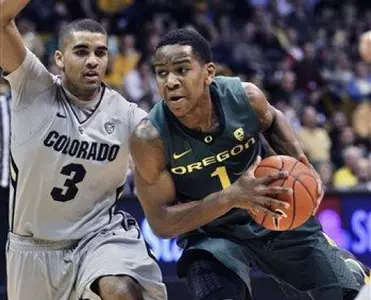 Oregon's Dominic Artis, right, drives