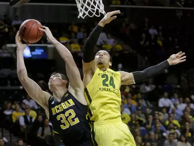 Michigan's Ricky Doyle (32) fights for