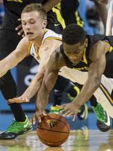 UCLA guard Nick Kazemi, left, and Oregon