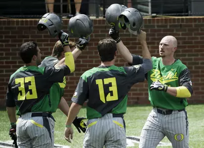 Kyle Garlick, right, congratulated by A.J. Balta (33) and Tyler Baumgartner (13)