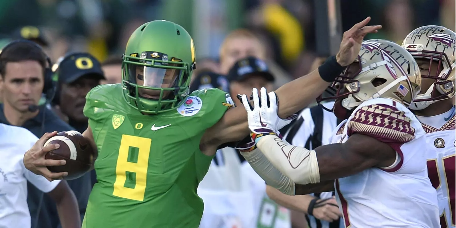 Marcus Mariota, left, pushes away Florida State safety Tyler Hunter