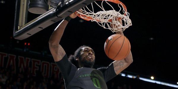 Oregon's Dwayne Benjamin (0) dunks over