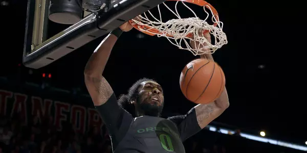 Oregon's Dwayne Benjamin (0) dunks over