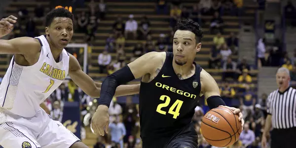 Oregon's Dillon Brooks, right, drives