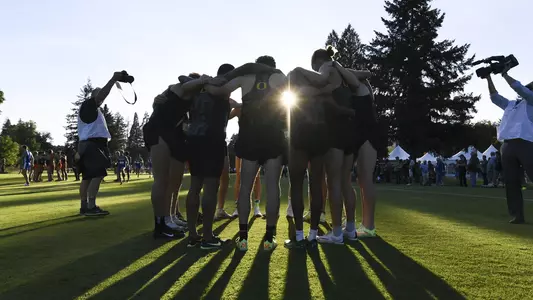 Men of Oregon team huddle at Dellinger