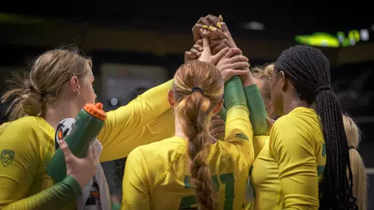 Team huddle, green-yellow scrimmage