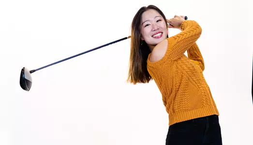 Heather Lin poses for a photoshoot with her golf club