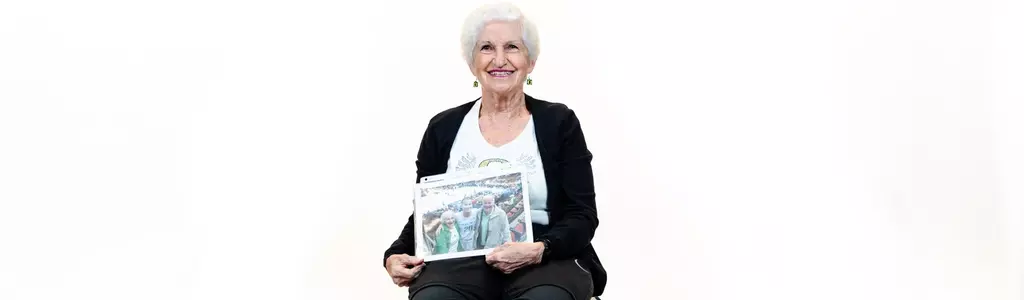 Becky Sisley poses for a photoshoot with her women's sports memorabilia