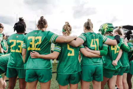 Oregon Lacrosse huddles before a match.