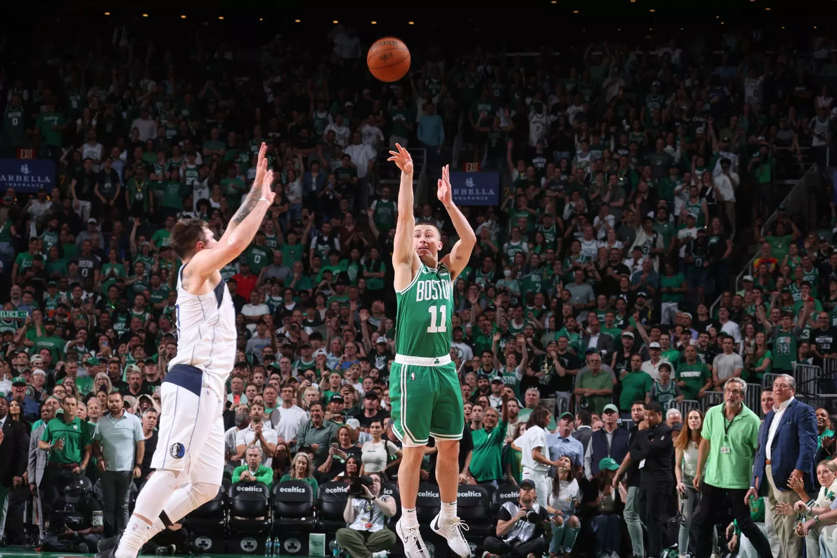 BOSTON, MA - JUNE 17: Payton Pritchard #11 of the Boston Celtics scores a buzzer beater during the game against the Dallas Mavericks during Game 5 of the 2024 NBA Finals on June 17, 2024 at the TD Garden in Boston, Massachusetts.