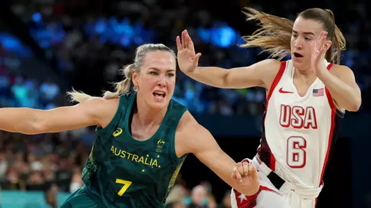 PARIS, FRANCE - AUGUST 09: Tess Madgen #7 of Team Australia drives past Sabrina Ionescu #6 of Team United States during a Women's semifinal match between Team United States and Team Australia on day fourteen of the Olympic Games Paris 2024 at Bercy Arena on August 09, 2024 in Paris, France. (Photo by Gregory Shamus/Getty Images)