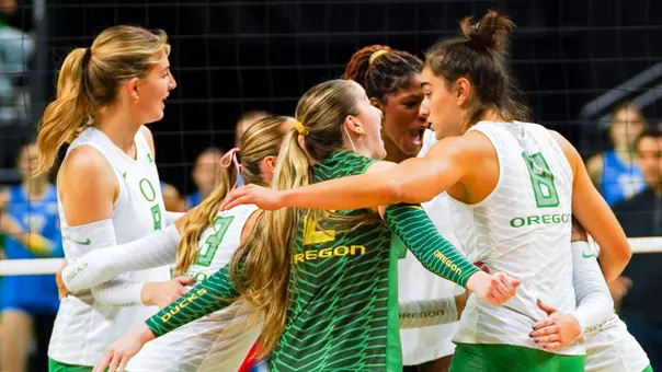 Team huddle, celebration vs UCLA (Nov. 6)