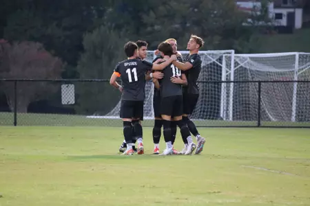 and is surrounded in celebration