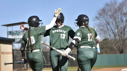 Homerun celebration with Alanna Deal, Carson Shaw, and Sophia Kardatzke