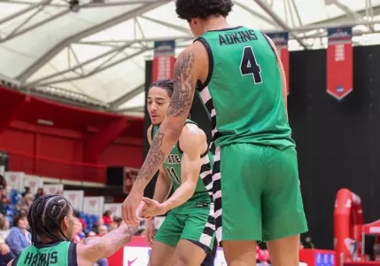 Carmelo Adkins and Karmani Gregory helping Brit Harris up