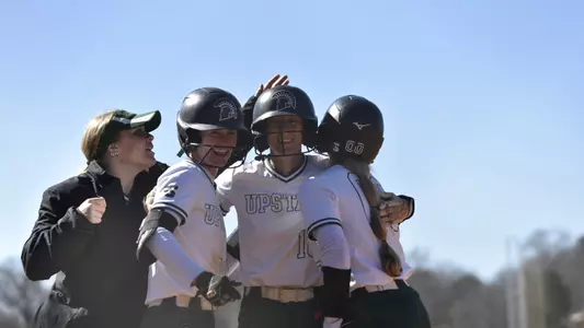 Alanna Deal being embraced after a home run against Charlotte (Feb. 28, 2025)