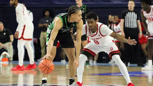 Karmani Gregory dribbling up the court at the Big South Men's Basketball Championships