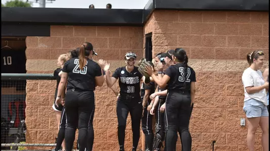 Amie Johnson going through the huddle for pregame lineups