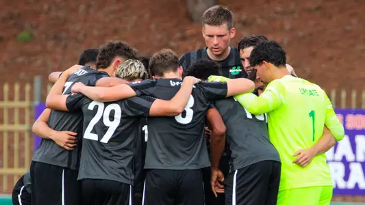 Men's Soccer huddle before taking the field against Clemson