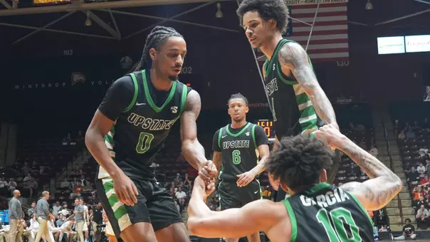 Tyler Smith and Carmelo Adkins helping Breylin Garcia against Winthrop (2/19/26)