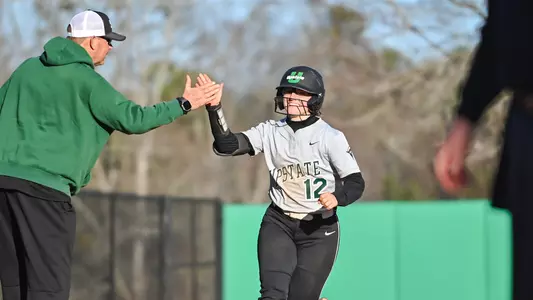 Laney Jennings celebrating with Coach Hawkins after one of four homeruns in one day