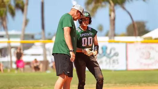 Coach Hawkins and Abby Polk after a triple to right field against CMU (3/8/26)