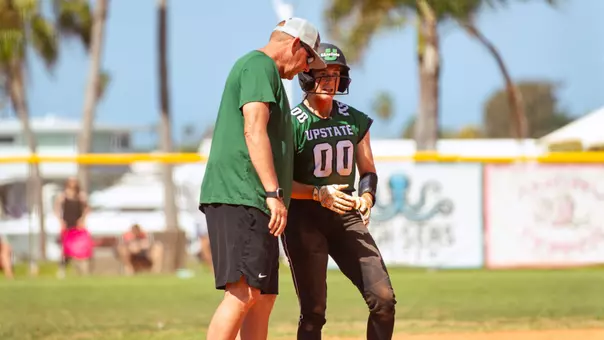 Coach Hawkins and Abby Polk after a triple to right field against CMU (3/8/26)