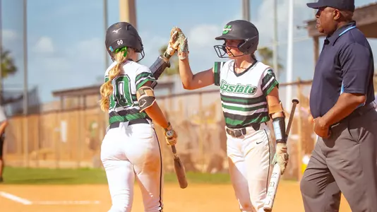 Abby Polk and Alyssa Davenport at the plate in Clearwater, Fla.