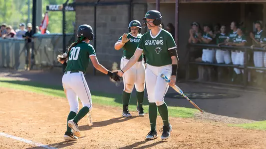 Sophia Kardatzke and Amie Johnson high five at Winthrop