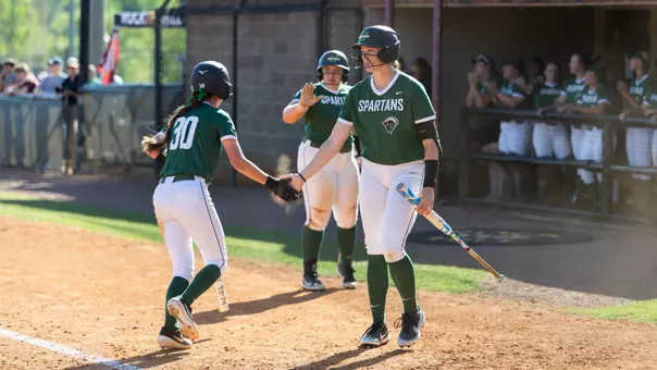 Sophia Kardatzke and Amie Johnson high five at Winthrop