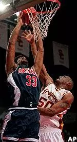 Sam Clancy goes up<br>to block Arizona's Eugene<br>Edgerson during first half.