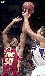 Sam Clancy, Jr. and<br>Kansas guard Ryan Robertson<br>go for a rebound<br>during the first half.