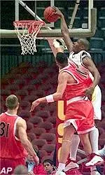 Jarvis Turner dunks over<br>Oregon State's Clifton Jones<br>during first half action.