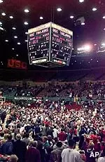 The delighted crowd storms<br>the Sports Arena floor.