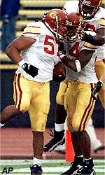 T Aaron Williams, center<br>left with ball, celebrates<br>his touchdown with teammates.