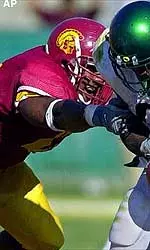 USC's Lonnie Ford, left, attempts to strip the ball from University of Oregon's Maurice Morris during the fourth quarter.