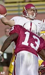 Southern California quarterback Carson Palmer passes under pressure by Stanford free safety Tank Williams (13) and defensive tackle Willie Howard (77) in the fourth quarter.