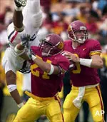 Quarterback Carson Palmer gets set to throw as Malaefou MacKenzie puts a block on Arizona's Idris Haroon during the first half.