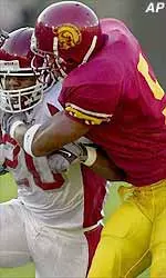 USC's DeShaun Hill, right, attempts to bring down Washington State's Deon Burnett in the second quarter.