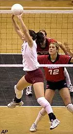 Toni Anderson sets up a return against Wisconsin during the NCAA Division I women's volleyball championship semifinals. Wisconsin's Jenny Maastricht defends.