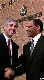 Newly-named head football coach Pete Carroll, left, shakes hands with USC Athletic Director Mike Garrett following the formal announcement of Carroll's hiring.