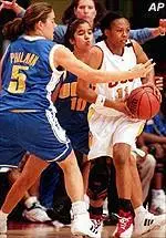 Erica Mashia looks for an outlet as UCLA's Marie Philman (5) and Erica Gomez set up the trap.