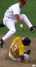 Anthony Lunetta leaps over Louisiana State's Ray Wright in third inning of a College World Series game Monday, June 12.