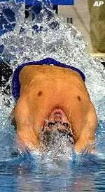 USC alum Lenny Krayzelburg won the gold medal and set a new Olympic record with his time of 53.72 seconds in the 100-meter backstroke.